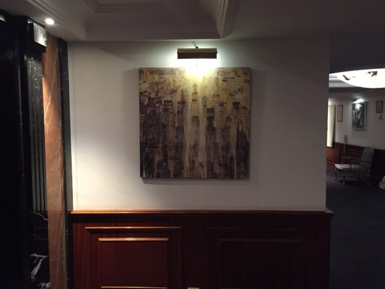 Cityscape painting under a picture light in the hotel room, Artrooms London 2018