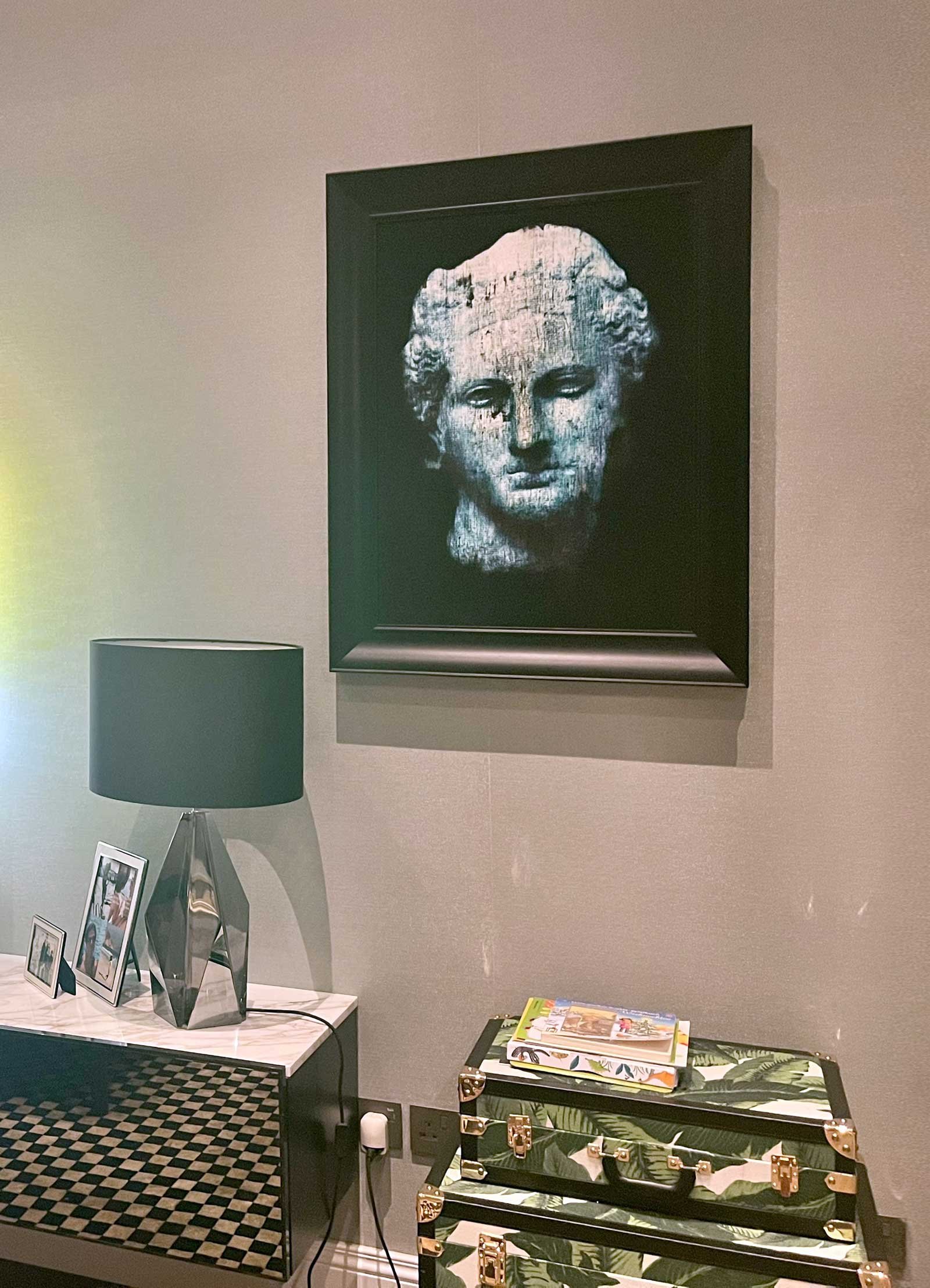 Framed blue bust painting by Dario Moschetta installed in a collector's home
