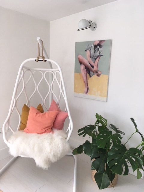 Seated female figure painting by Dario Moschetta in a modern interior