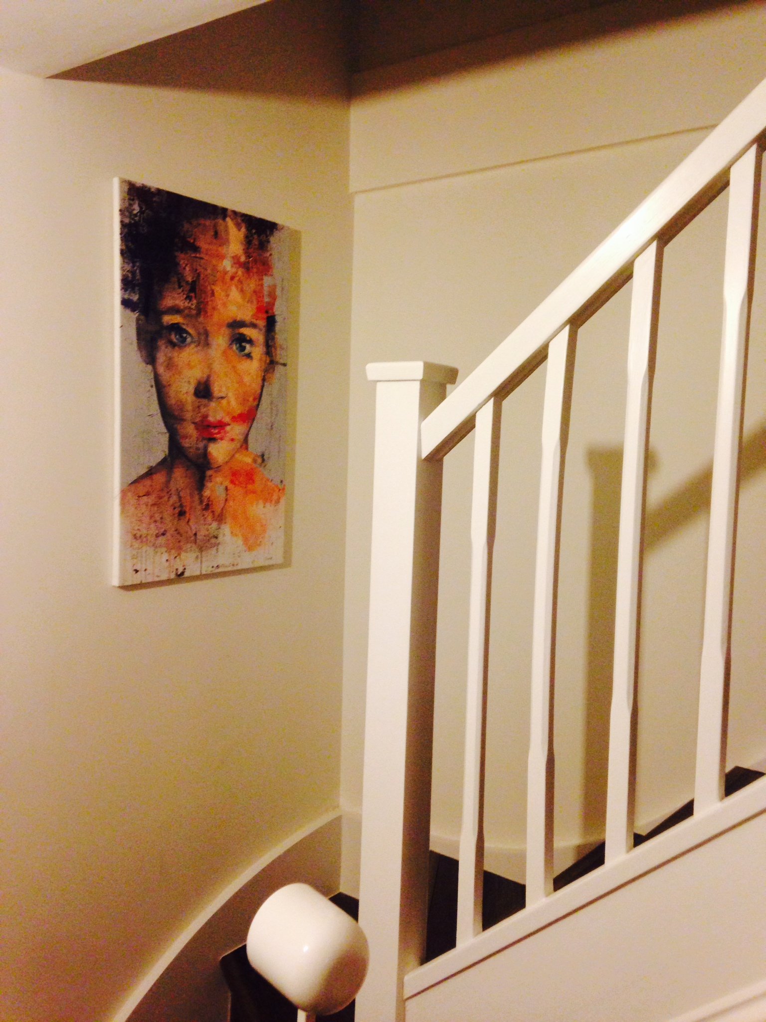 Female portrait painting by Dario Moschetta installed in a staircase interior