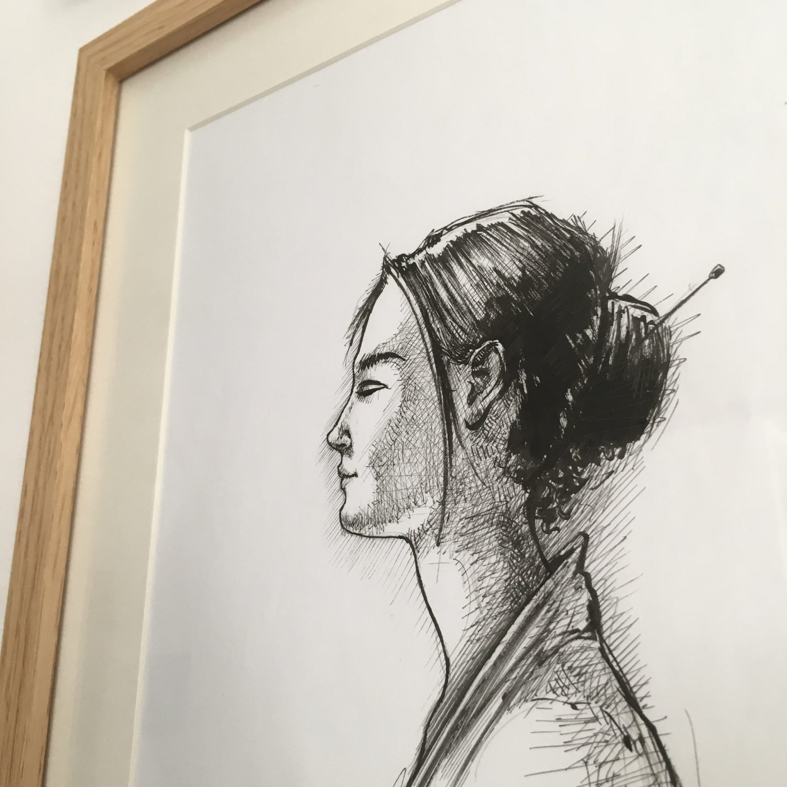 Framed ink drawing of female profile by Dario Moschetta in private interior