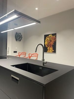Yellow bust painting by Dario Moschetta installed in modern kitchen