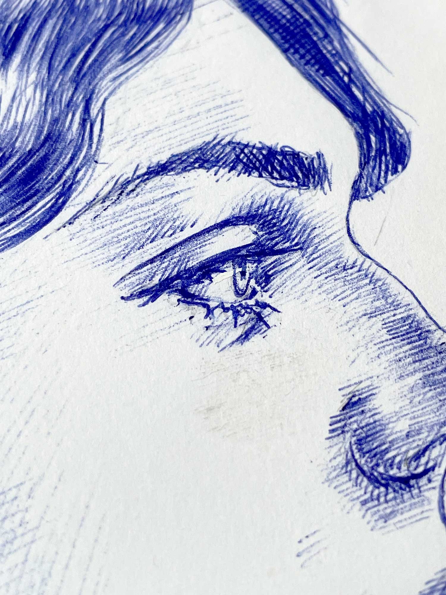 Detail of eye and facial features from blue ballpoint female portrait drawing