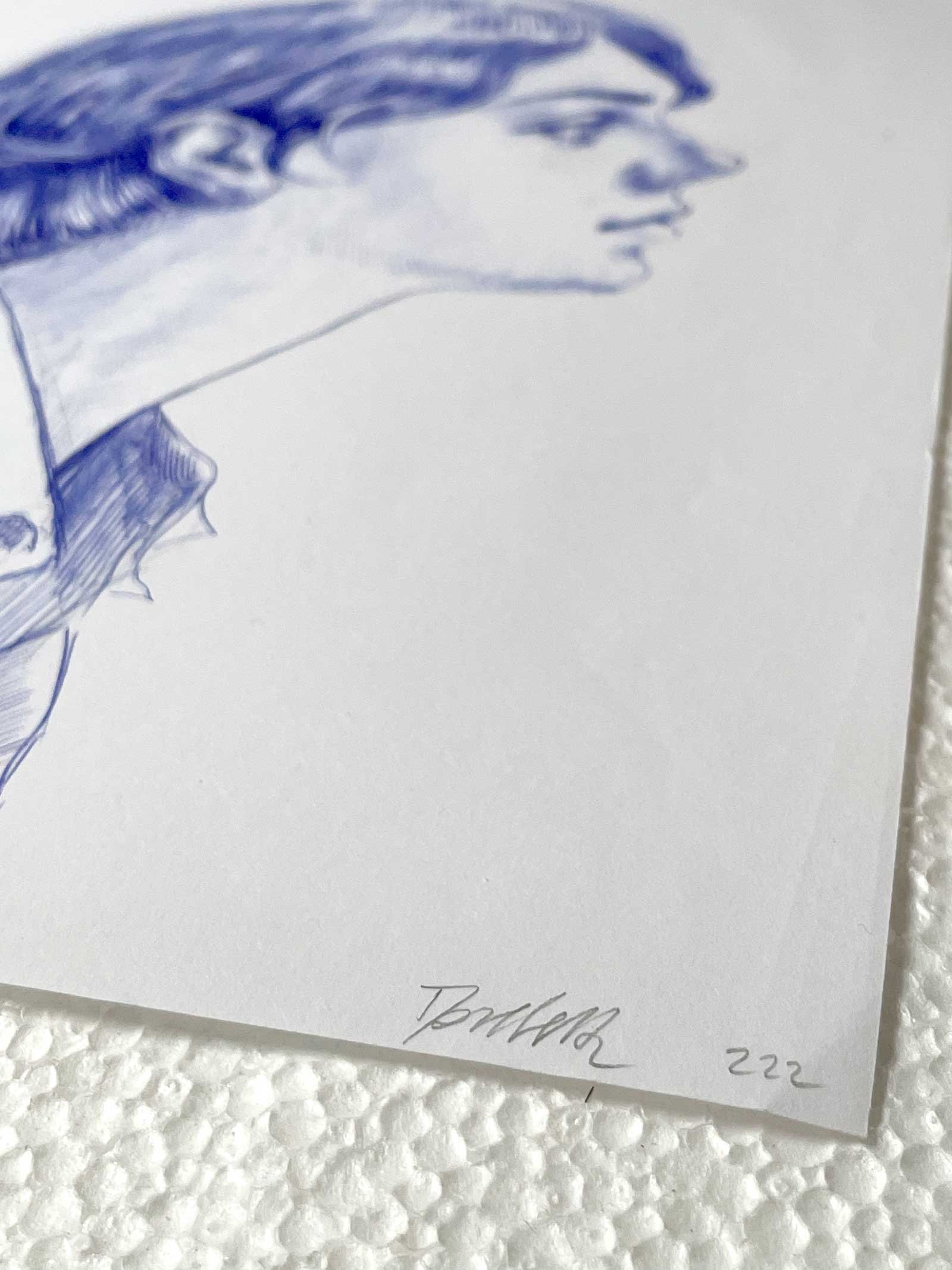 Signature detail of Dario Moschetta on blue ballpoint female portrait drawing