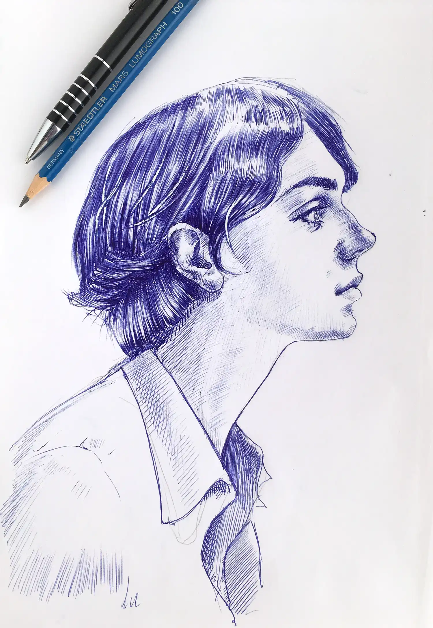 Female portrait drawing in blue ballpoint pen with pencil beside – original artwork by Dario Moschetta