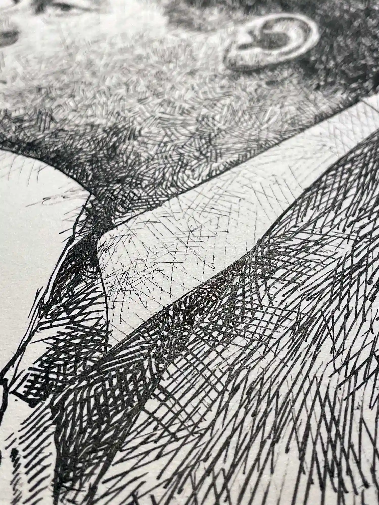 Ink drawing close-up highlighting the artist’s precise mark-making and tonal contrast in the male portrait