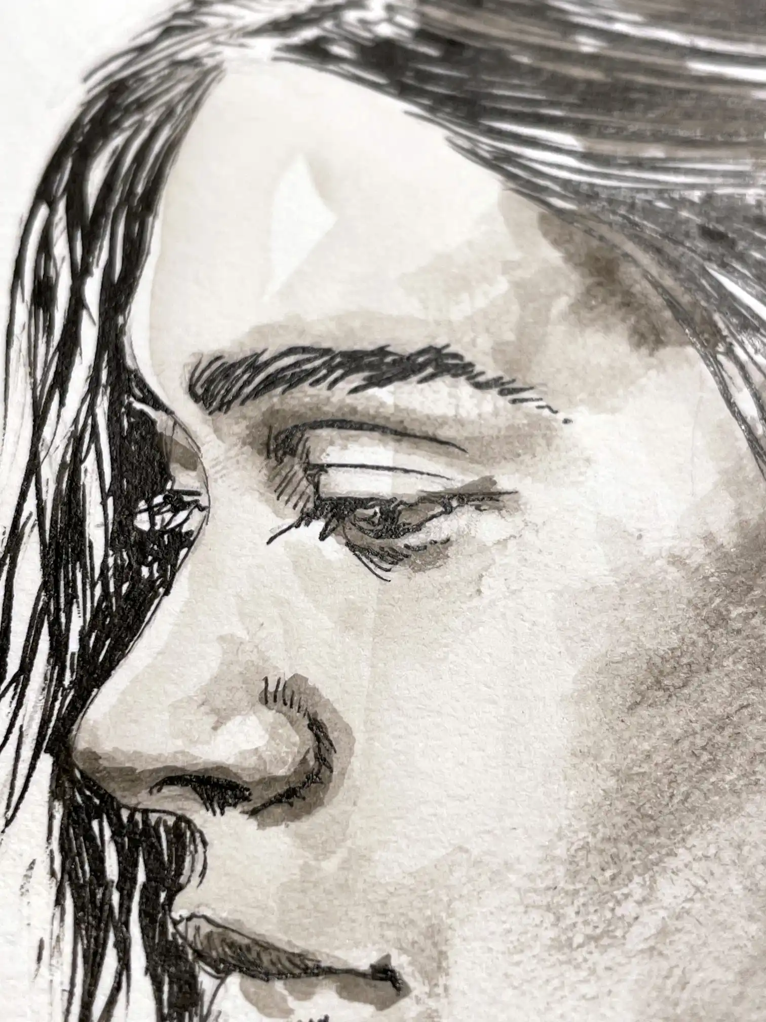 Facial detail of the ink and watercolor portrait by Dario Moschetta, highlighting delicate graphite shading.
