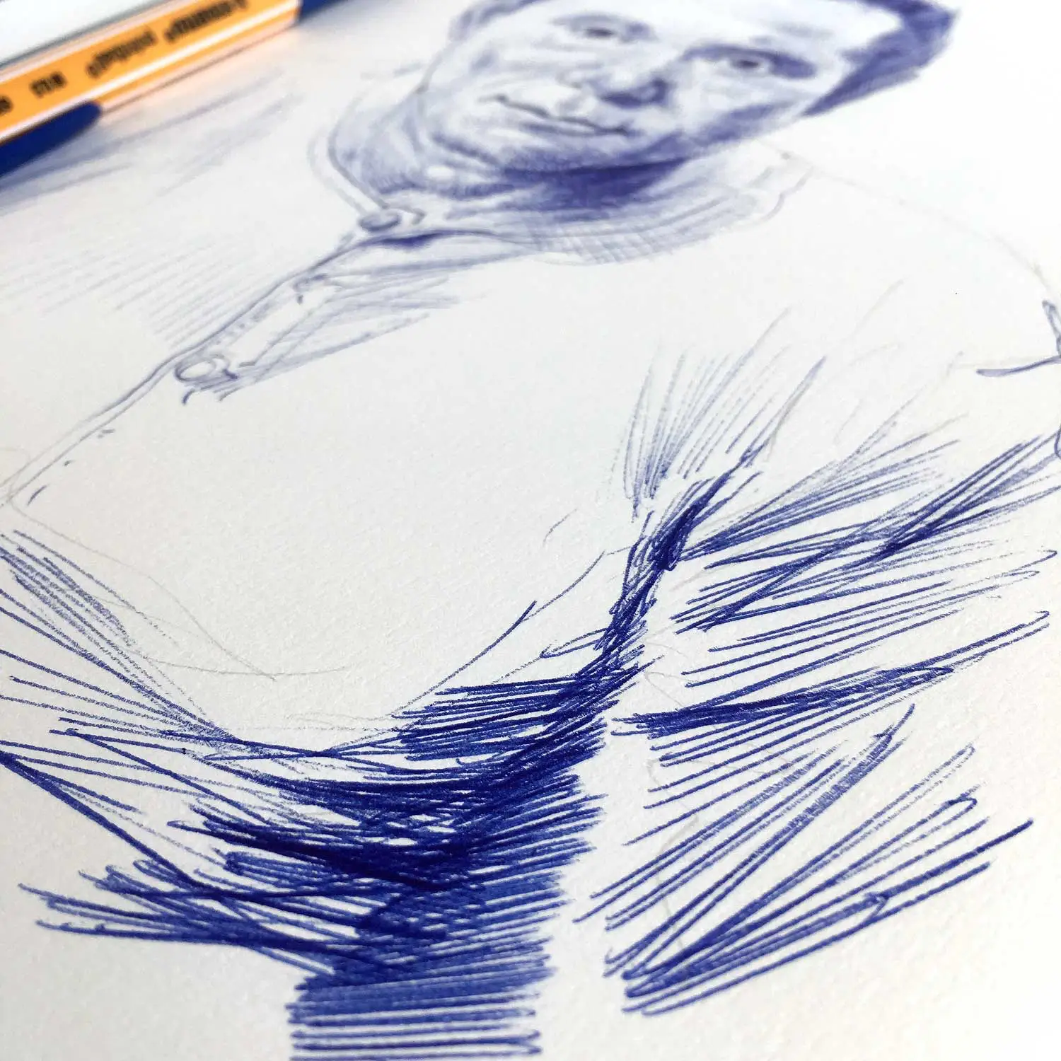 Close-up of male ballpoint portrait drawing showing ink linework and texture