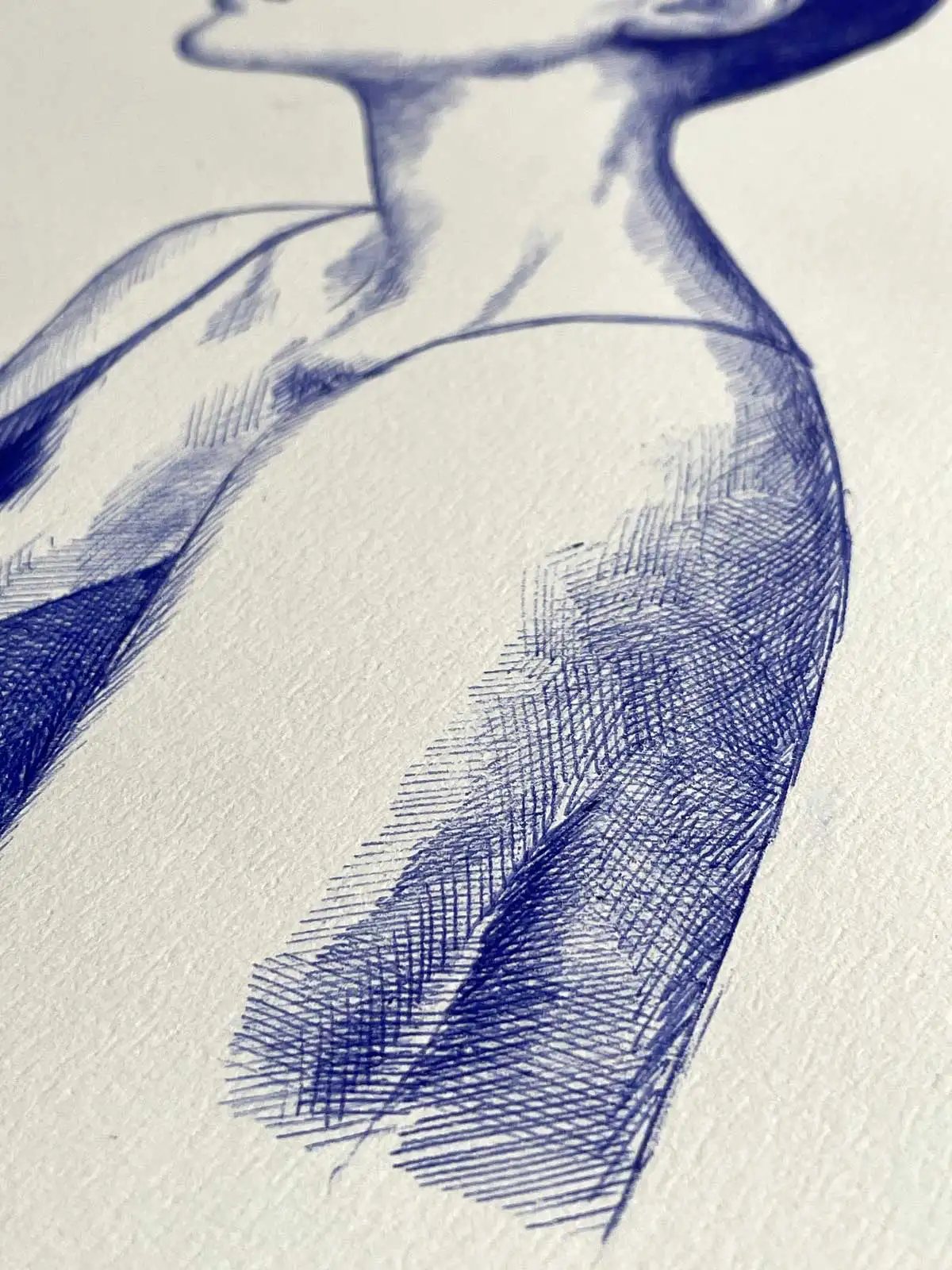 Close-up of a female portrait in blue ballpoint ink on A4 paper, highlighting the shading and texture on the arm