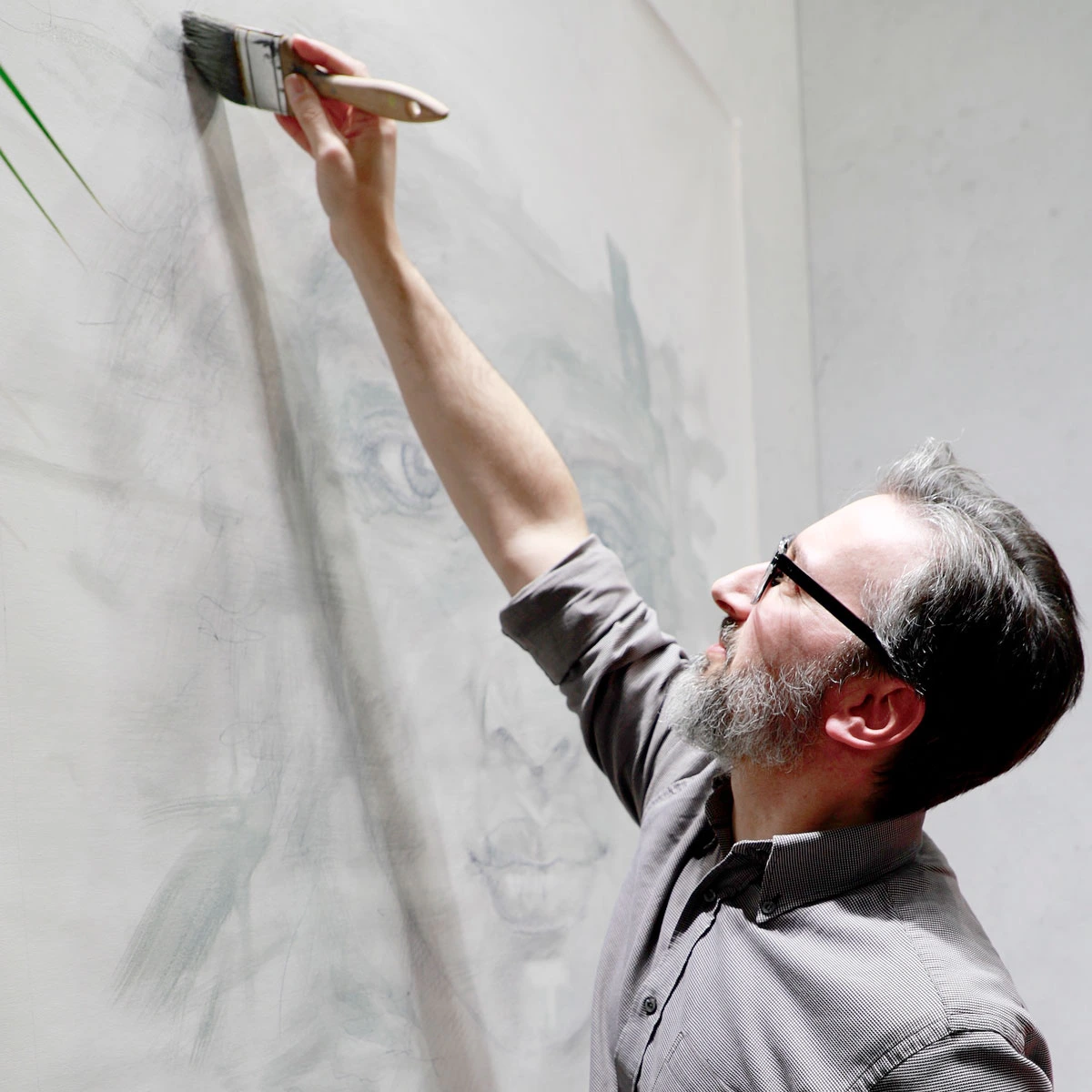 Artist working in the studio within an artist-run contemporary art auction context