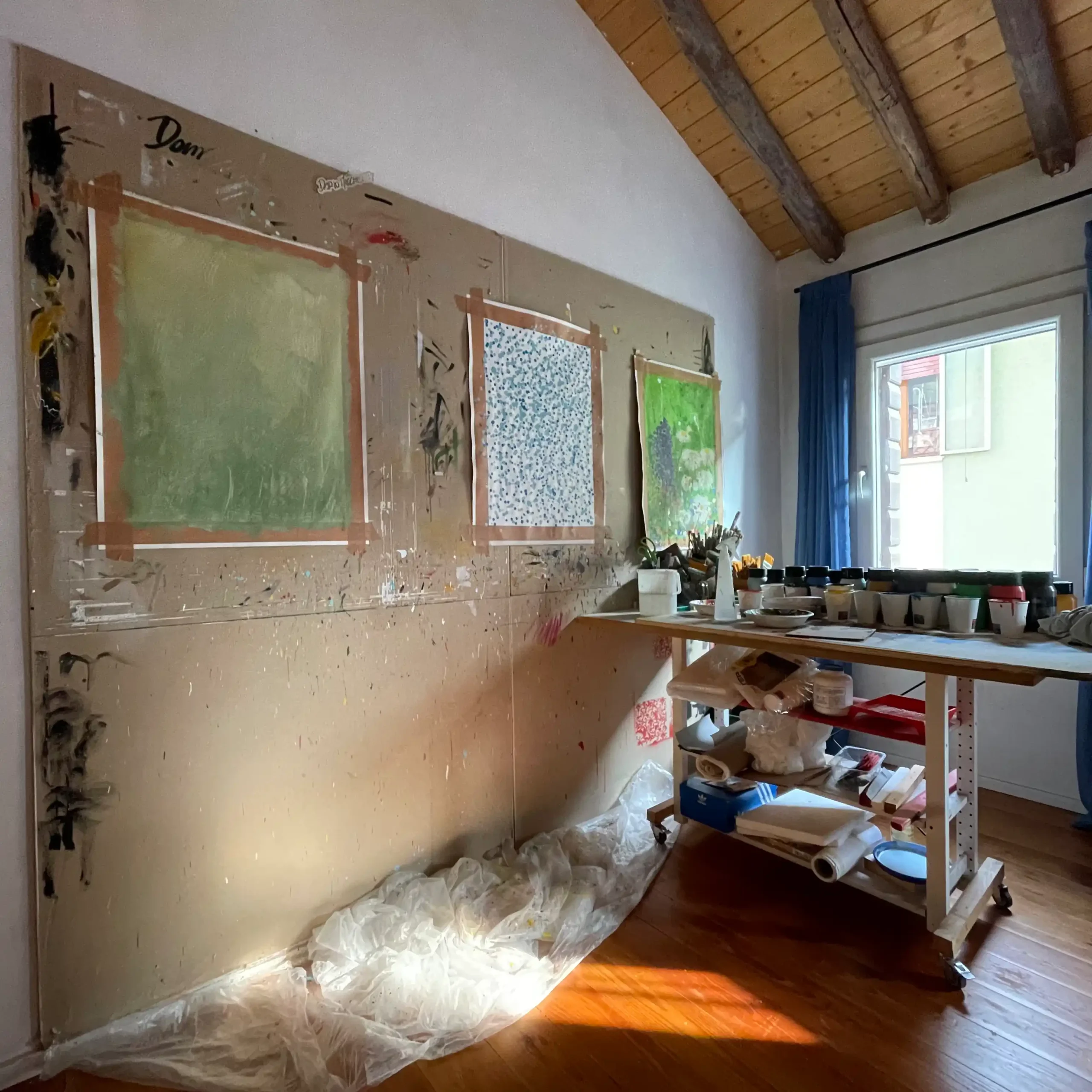 Artist studio view showing contemporary artworks prepared for a digital art auction