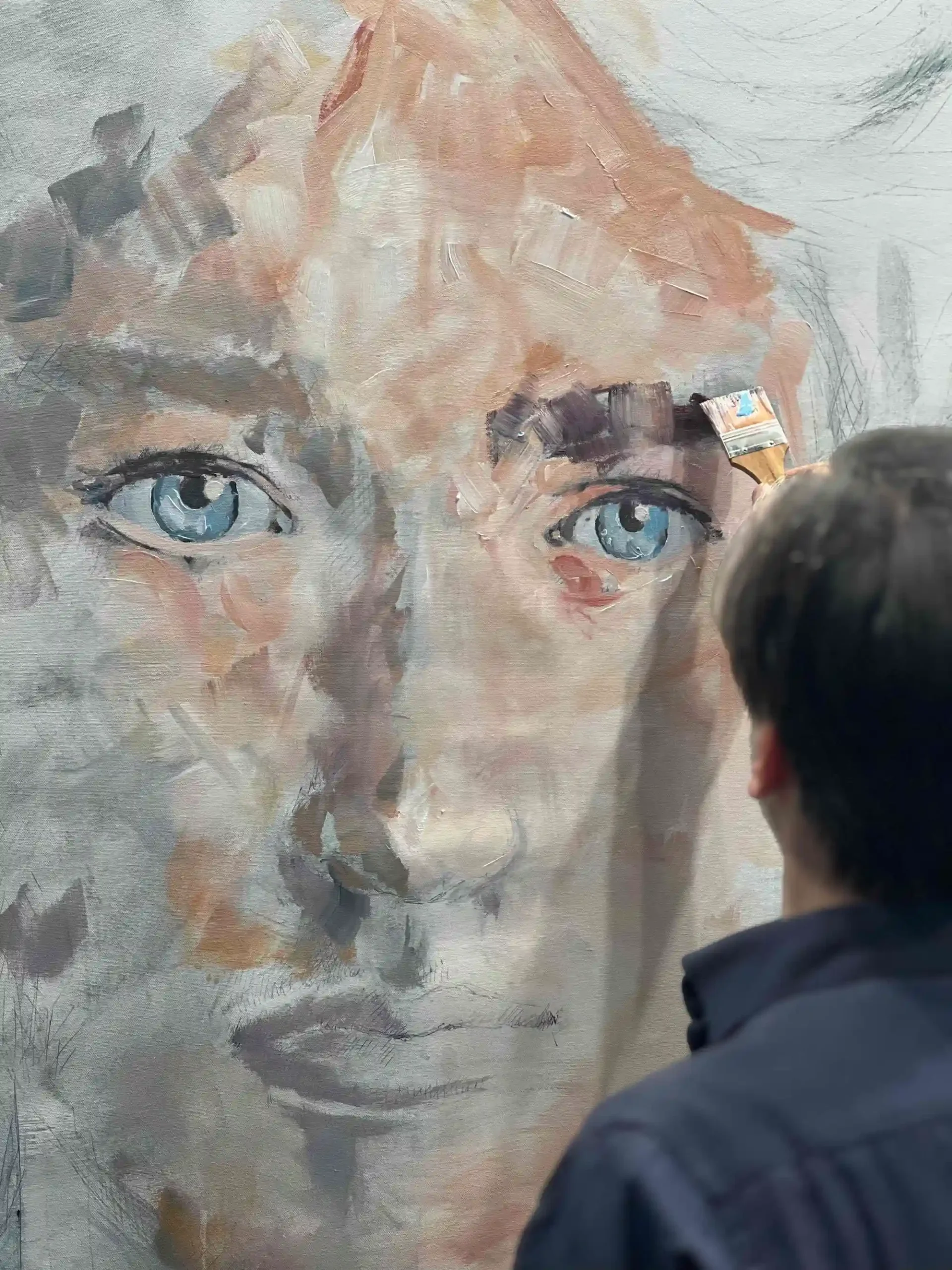 Visionary contemporary artist close-up painting process focusing on expressive eyes