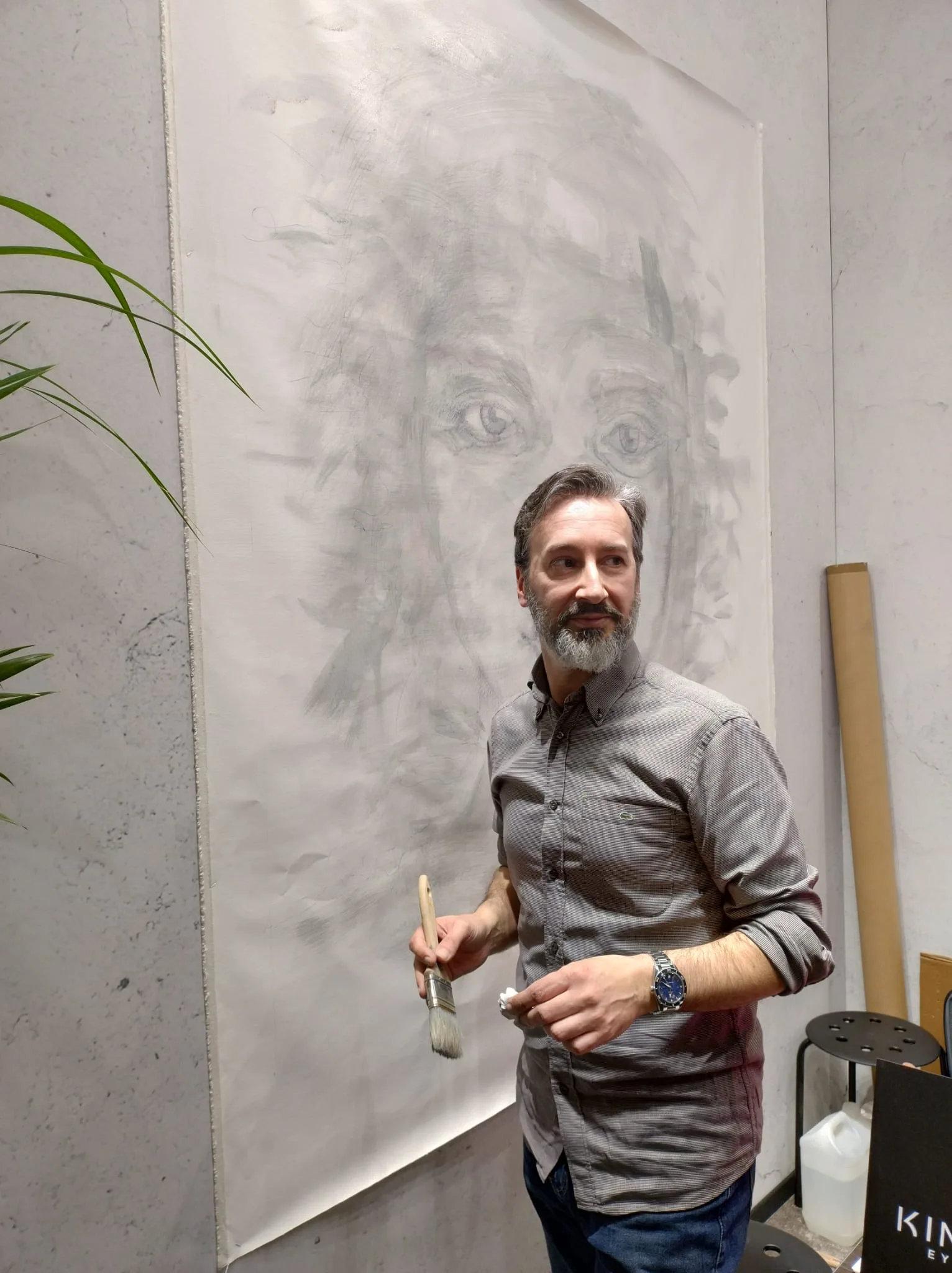 Contemporary artist working in his studio during the painting process, illustrating how recognition forms before visibility in contemporary art