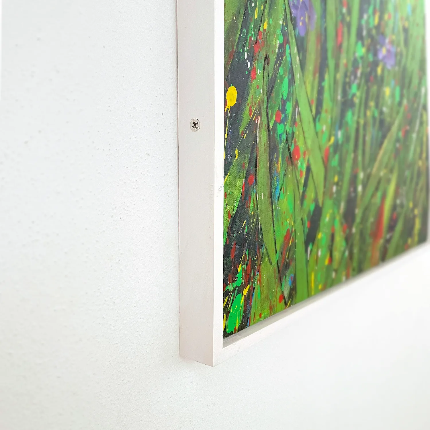 Side profile of handcrafted white wooden frame for abstract floral painting