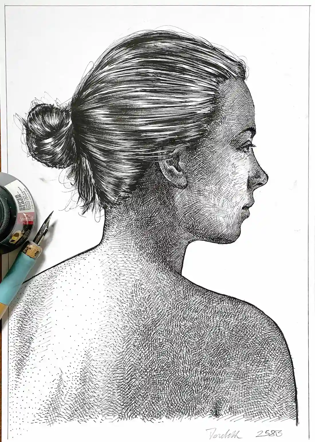 black ink female portrait drawing for sale on paper studio view with tools