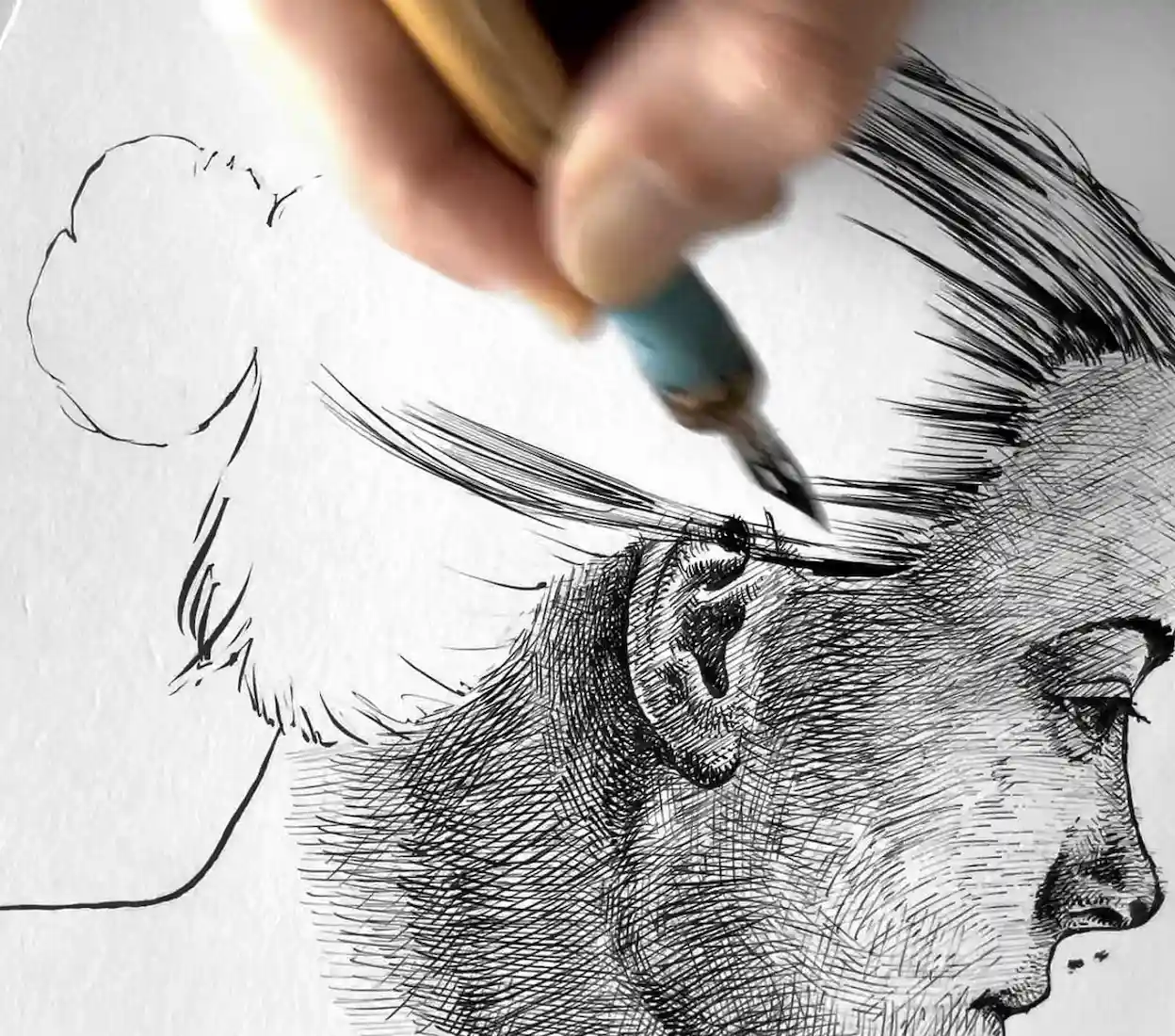 black ink female portrait drawing in progress on paper with dip pen