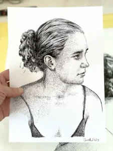 Female side profile ink drawing held by the artist – Portrait 262B