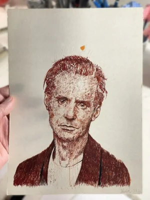 Red ink portrait drawing held by the artist – Portrait 292